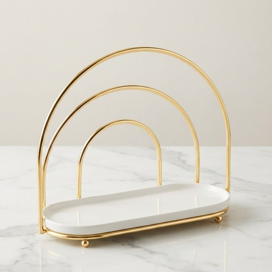 Gold and white serving stand on a marble surface