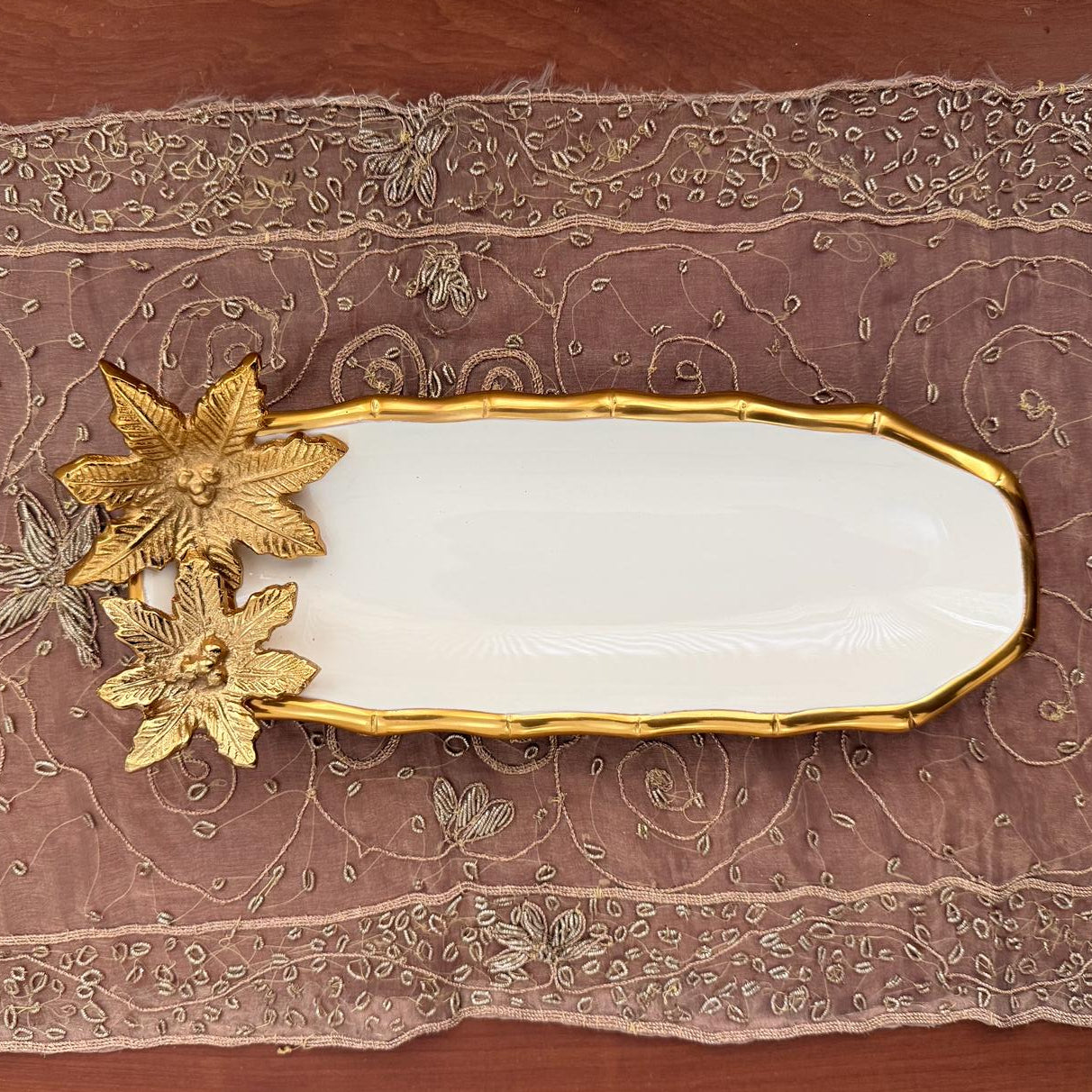 Decorative wall piece with gold leaf design on a textured brown background