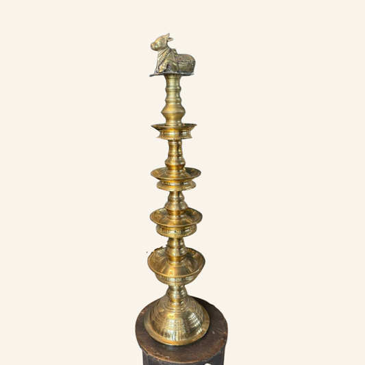 Brass lamp with intricate design on a white background