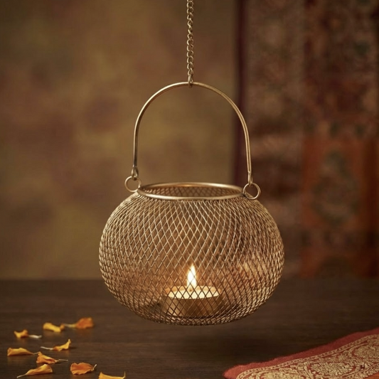 Decorative hanging lantern with a candle inside on a wooden surface.
