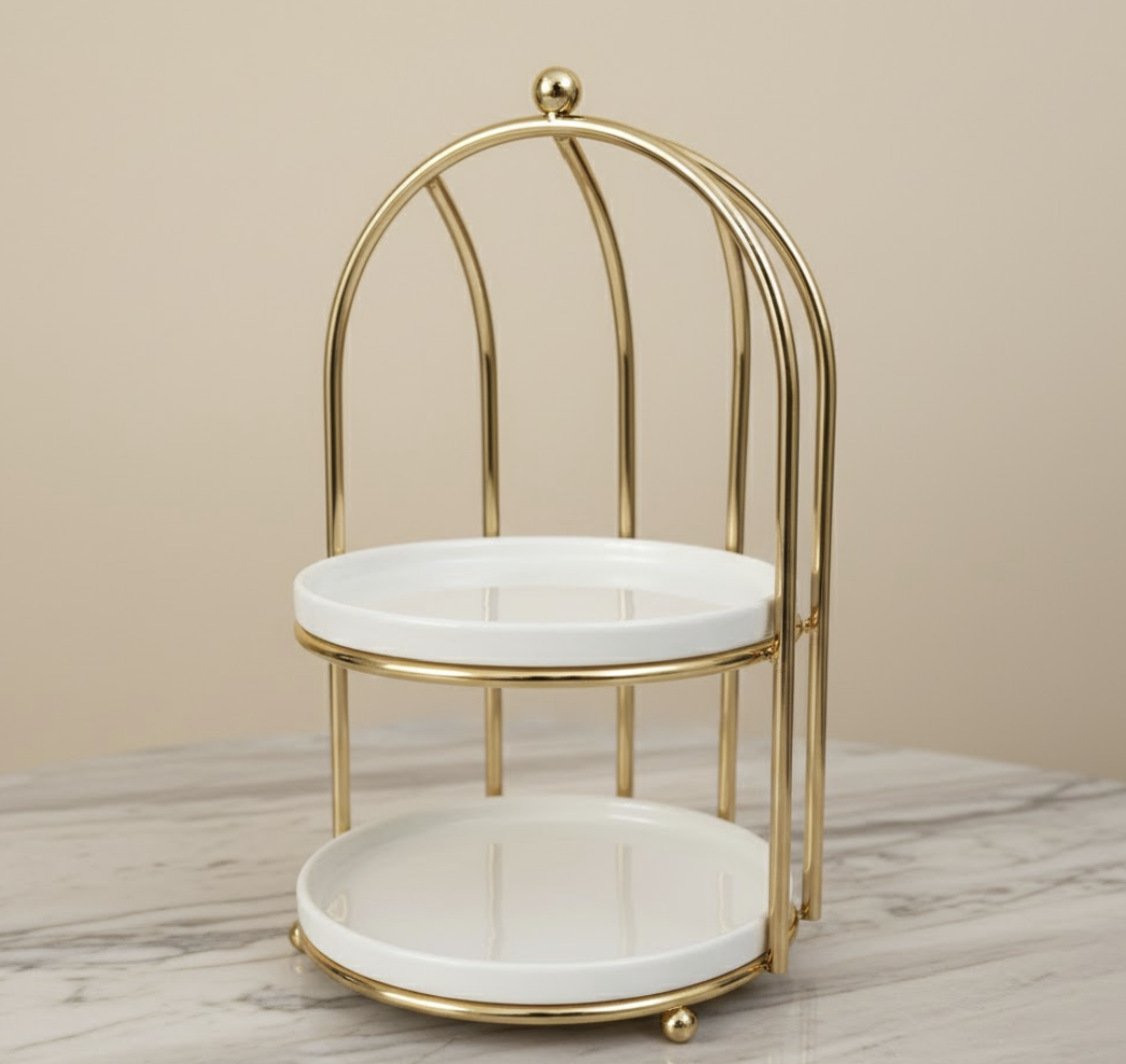 Two-tiered gold and marble stand on a neutral background