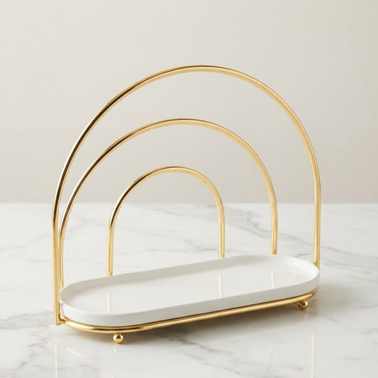 Gold and white serving stand on a marble surface