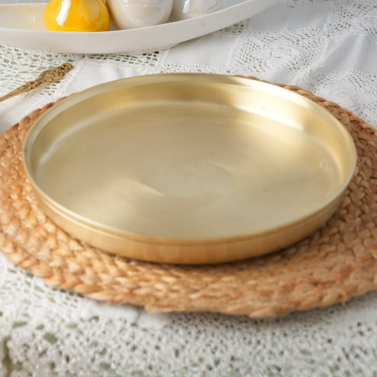 Bronze thali plate placed on a mat